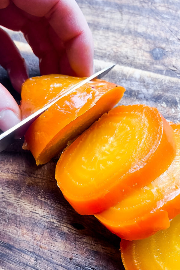 slicing a yellow roasted beet