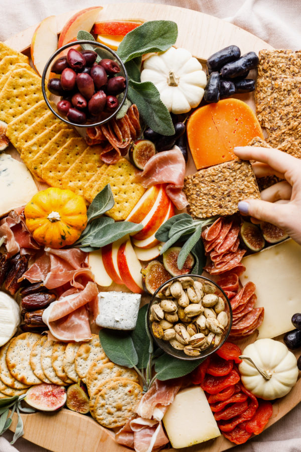 holding a cracker on cheese board