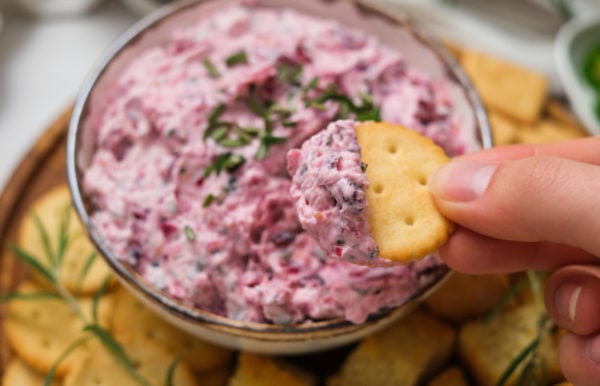 taking a bite of Cranberry Jalapeno Dip