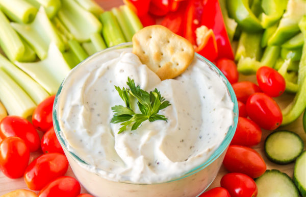 a cracker in greek yogurt dip