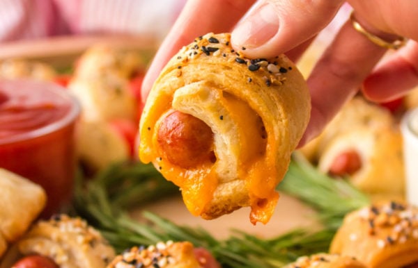 taking a cheesy bite of Pigs In A Blanket