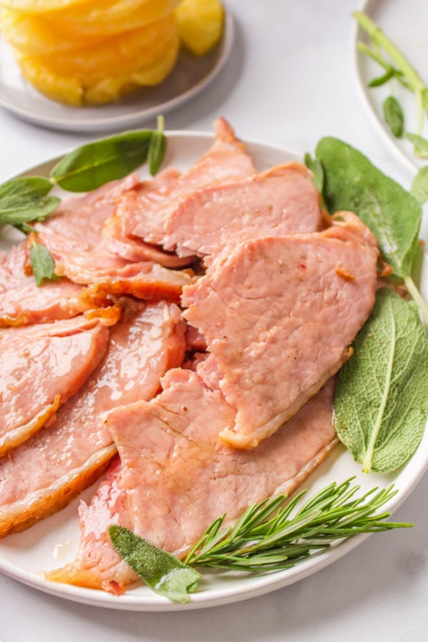 serving of crock pot ham on a plate with garnish