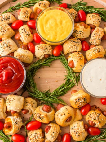 Pigs In A Blanket Wreath with mustard, ketchup, ranch