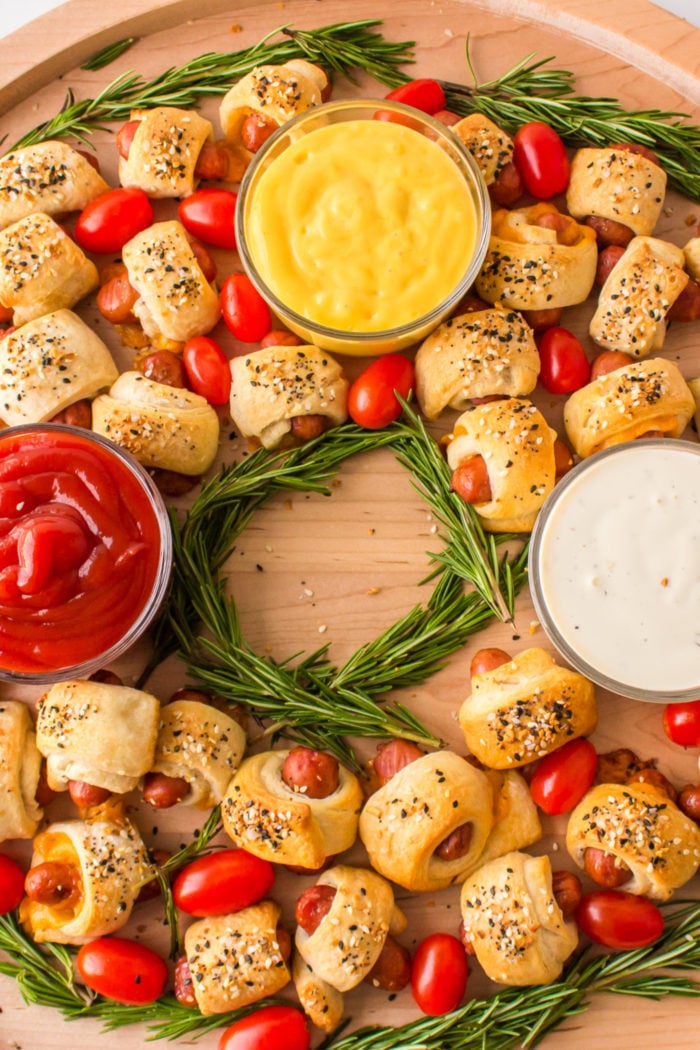 Pigs In A Blanket Wreath with mustard, ketchup, ranch