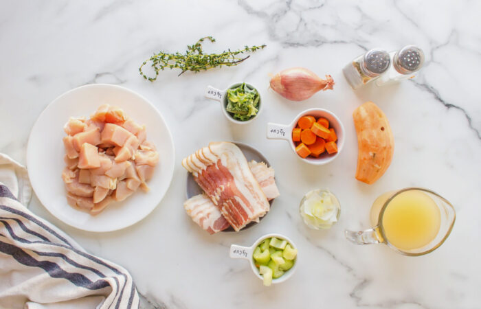 ingredients for a chicken soup with bacon and potatoes