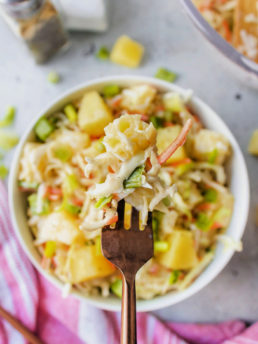 a bite of pineapple slaw with carr