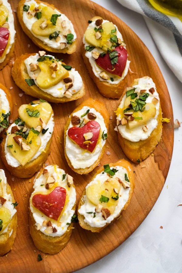 whipped ricotta crostini on wood plate