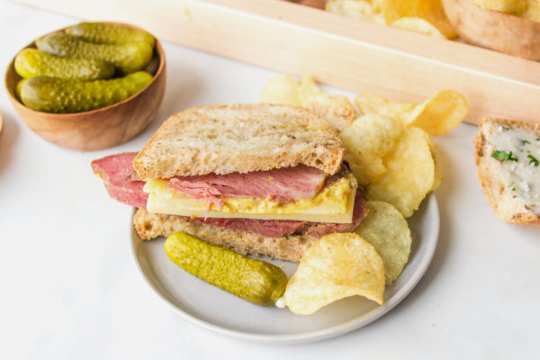 corned beef sandwich with potato chips and pickle