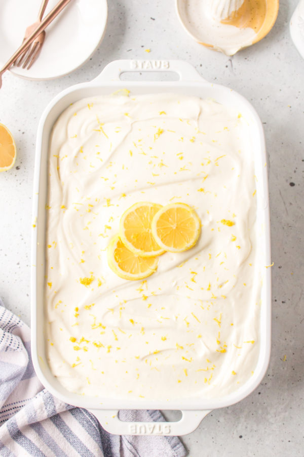 9x13 cake with whiopped cream and lemon garnish