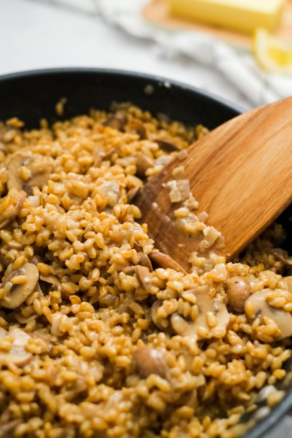 stirring rice and mushrooms