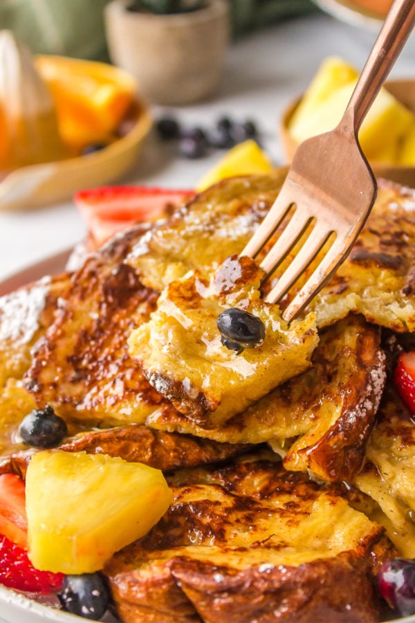 a bite of french toast with fruit