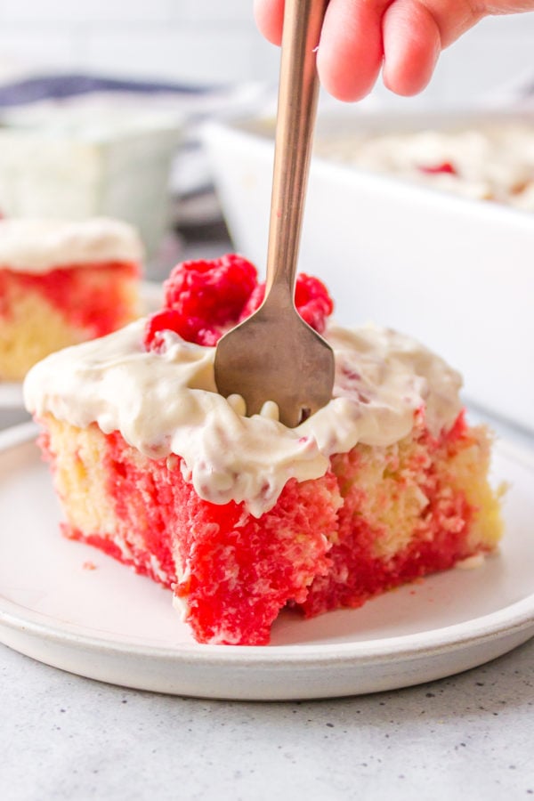 taking a bite of raspberry cake