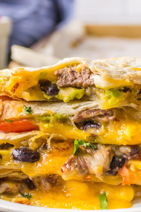 taking a bite of Steak Quesadilla