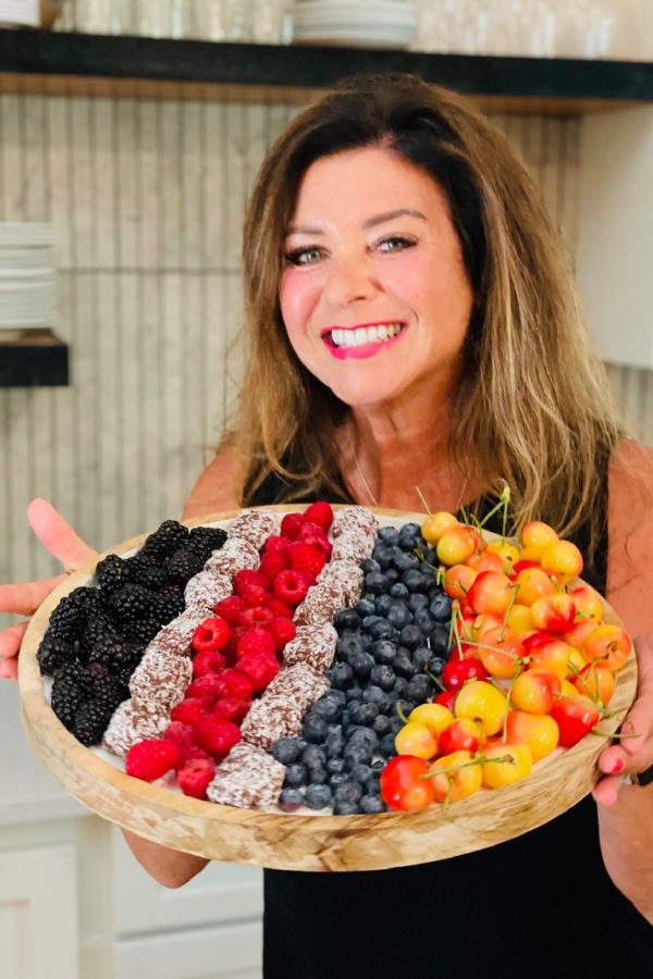 a woman holidng a 4th of July Fruit Tray