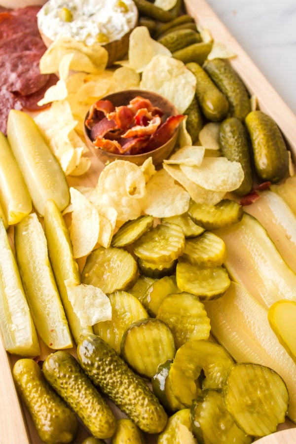 making a board with pickles and potato chips