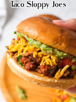 a taco burger with grated cheese