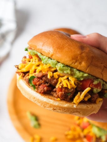 holding a Taco Sloppy Joe burger