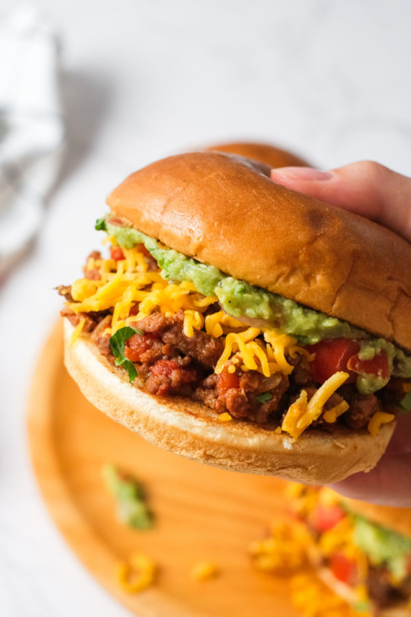 holding a Taco Sloppy Joe burger