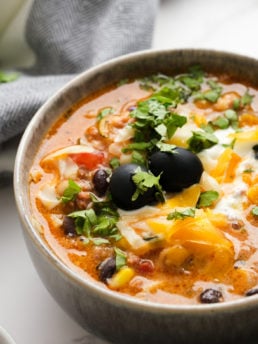 Bowl of Mexican soup with olives