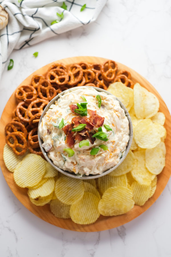 dip on platter with chips and pretzels