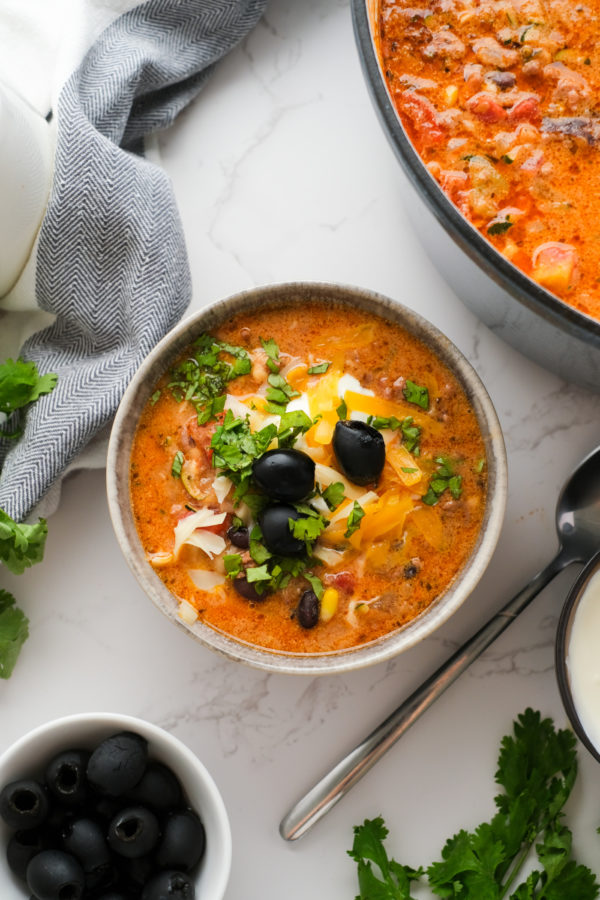 bowl of soup with cheese and olive