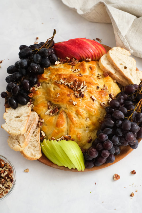 fruit and bread with a baked brie stuffed with figs
