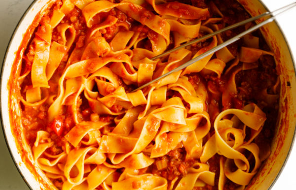 mixing red sauce to Pappardelle Pasta