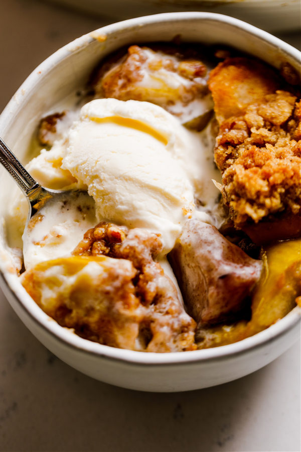 a warm bowl of apple crisp and melted ice cream