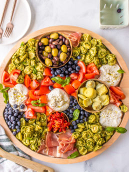 a salad board with burrata and tortellini