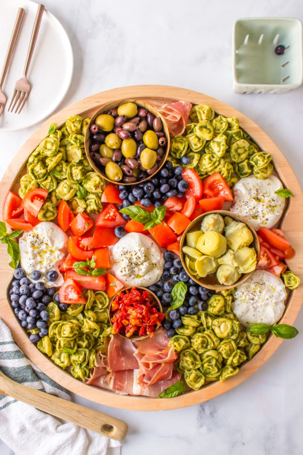 a salad board with burrata and tortellini