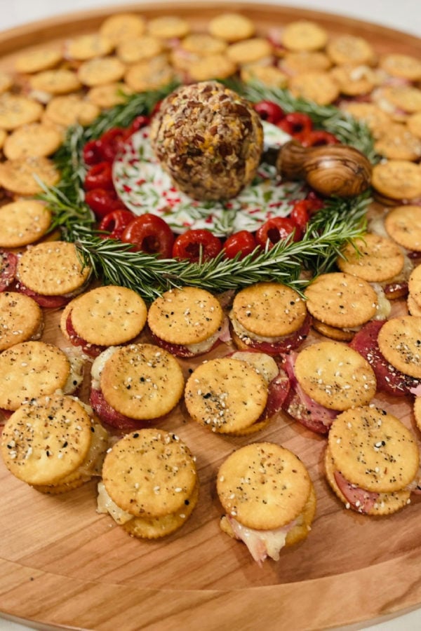 a big board with Ritz cracker sandwiches with ham