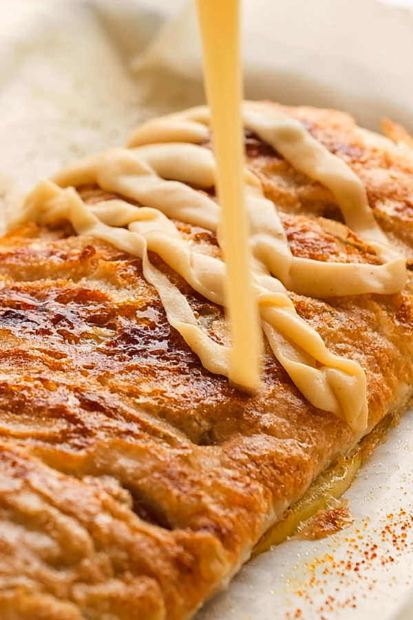 drizzling frosting on Apple Puff Pastry Braid