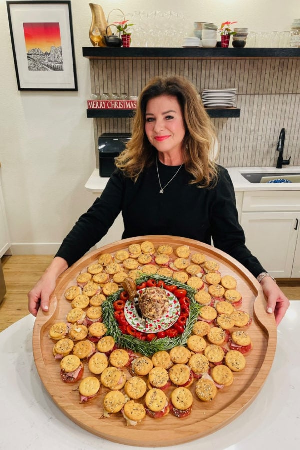 woman holding a big board with Ritz Cracker Party Sandwiches