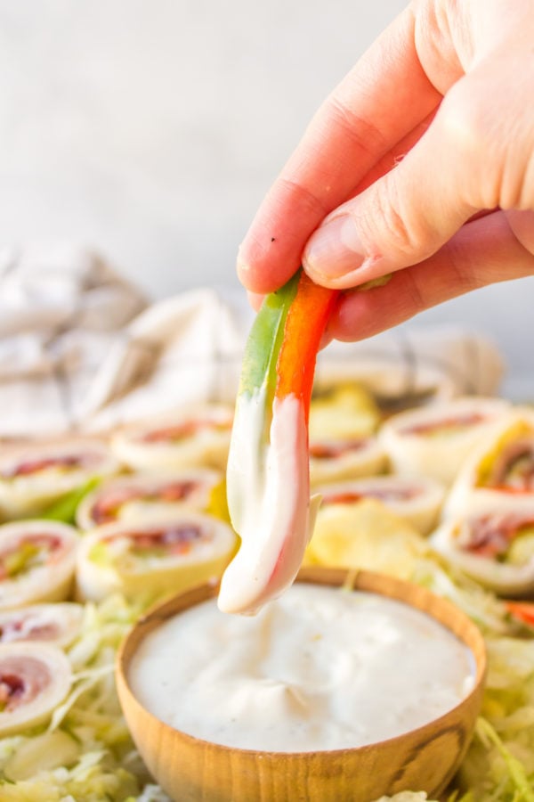 dipping peppers in Ranch dressing