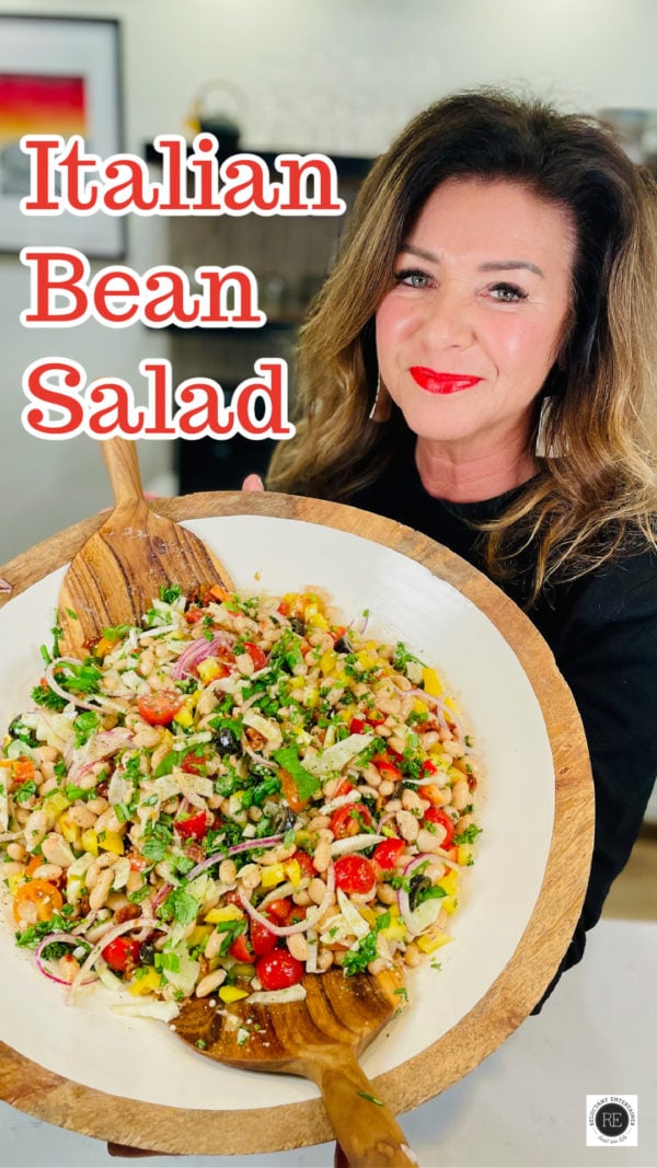 woman holding an epic salad bowl of Italian Bean Salad