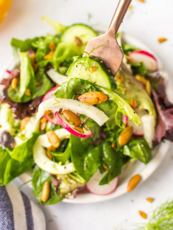 a salad with greens and dressing