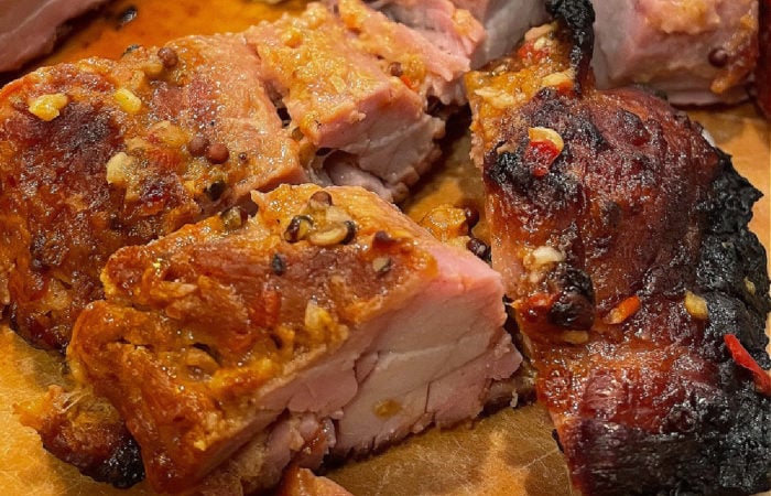 a bite of grilled pork
