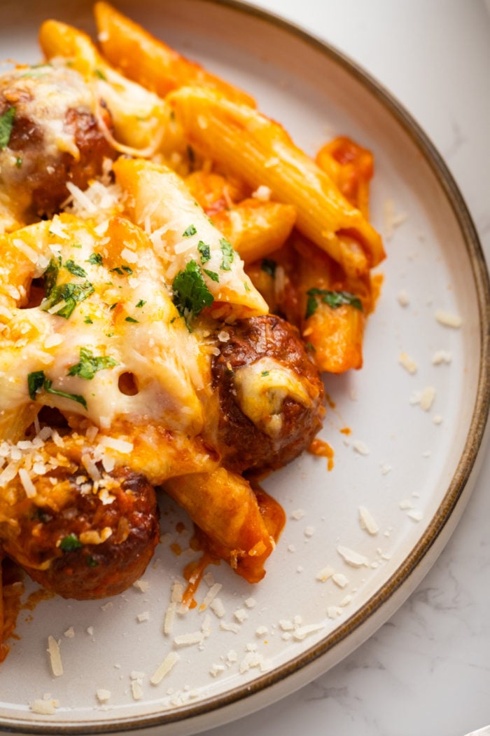 a serving of dump and bake meatball casserole with fresh parsley