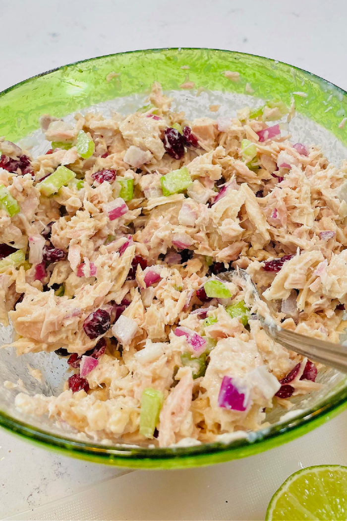 salad with tuna and apples in a green bowl