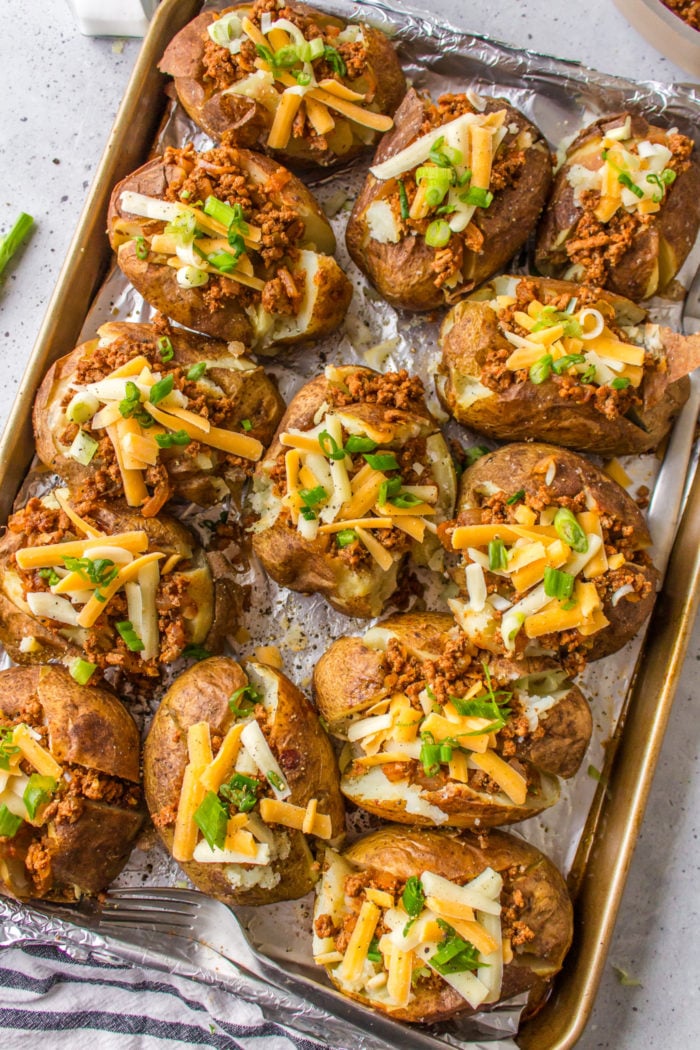 baked potatoes on baking sheet with taco meat