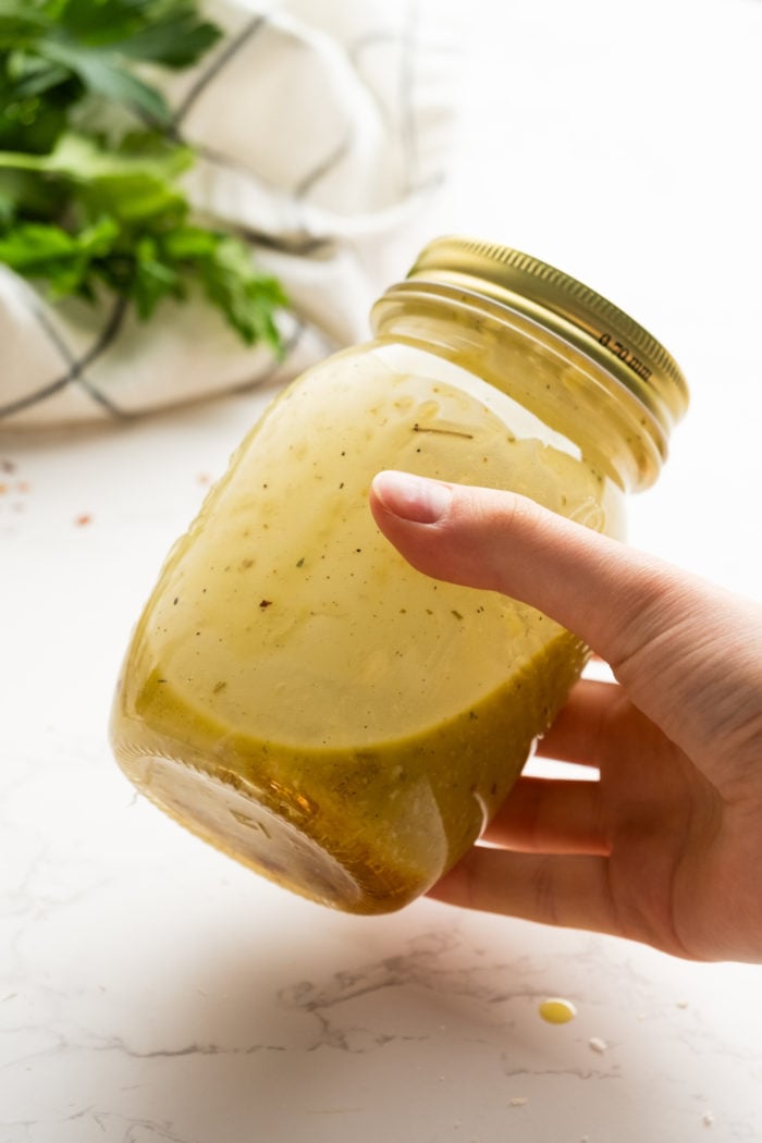 shaking a jar of salad dressing