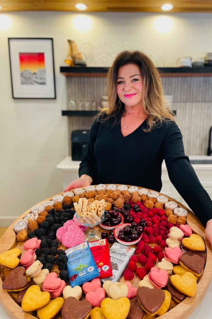 woman holding a big board with Valentine sweets