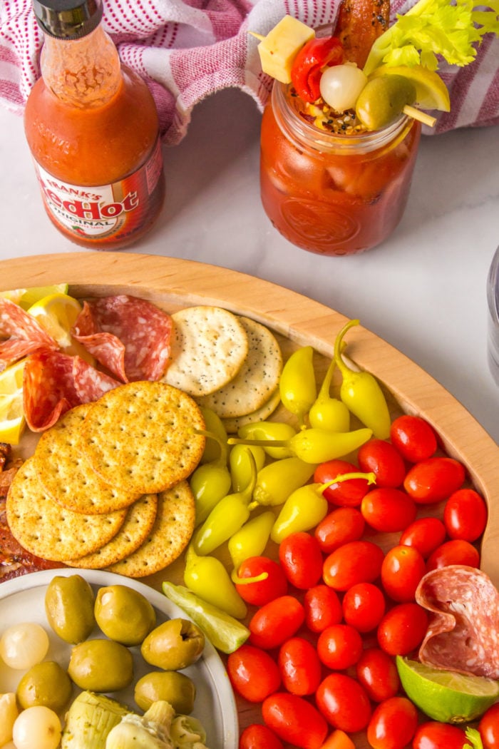 a bloody mary charcuterie board with crackers
