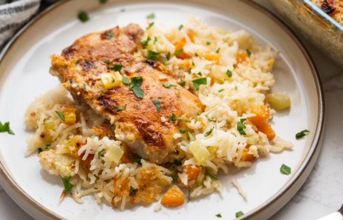 a serving of rice with chicken thigh