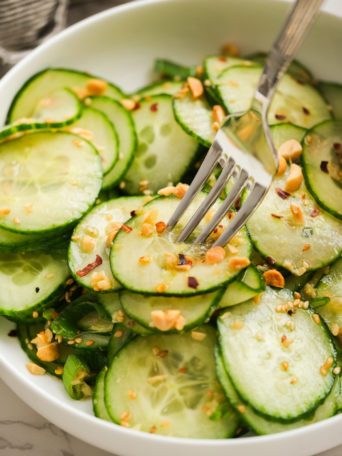 taking a bite of cucumber salad