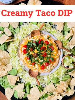 creamy taco dip served on a big board with chips