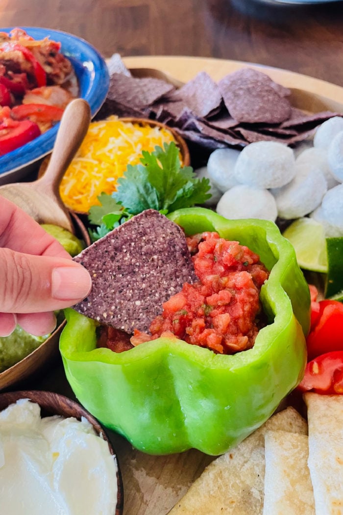 dipping a chip into salsa