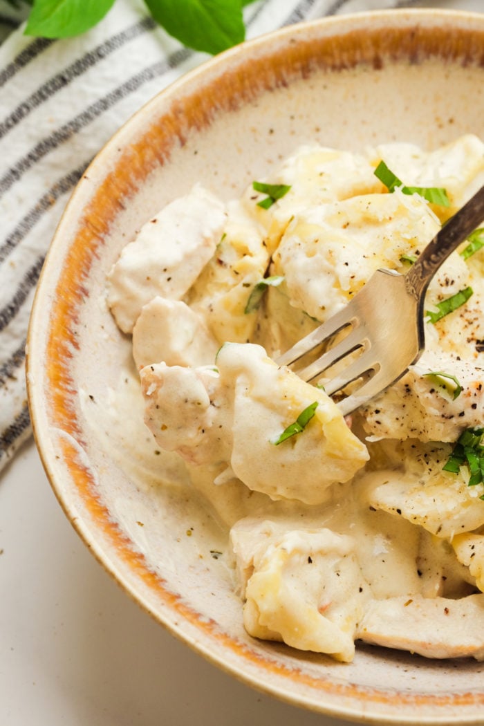 taking a fork bite of Tortellini Chicken