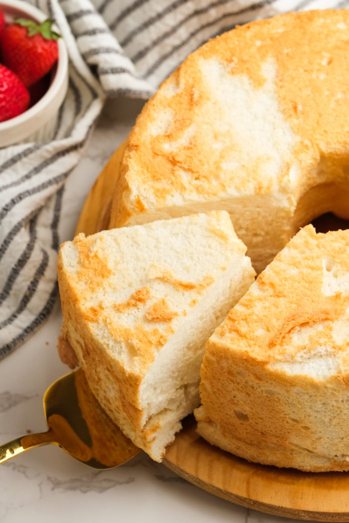 cutting a piece of angel food cake