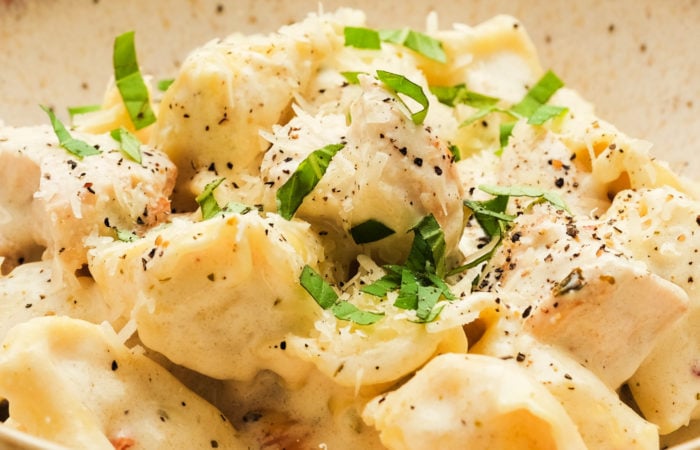 fresh tortellini cooked with chicken and cheese sauce